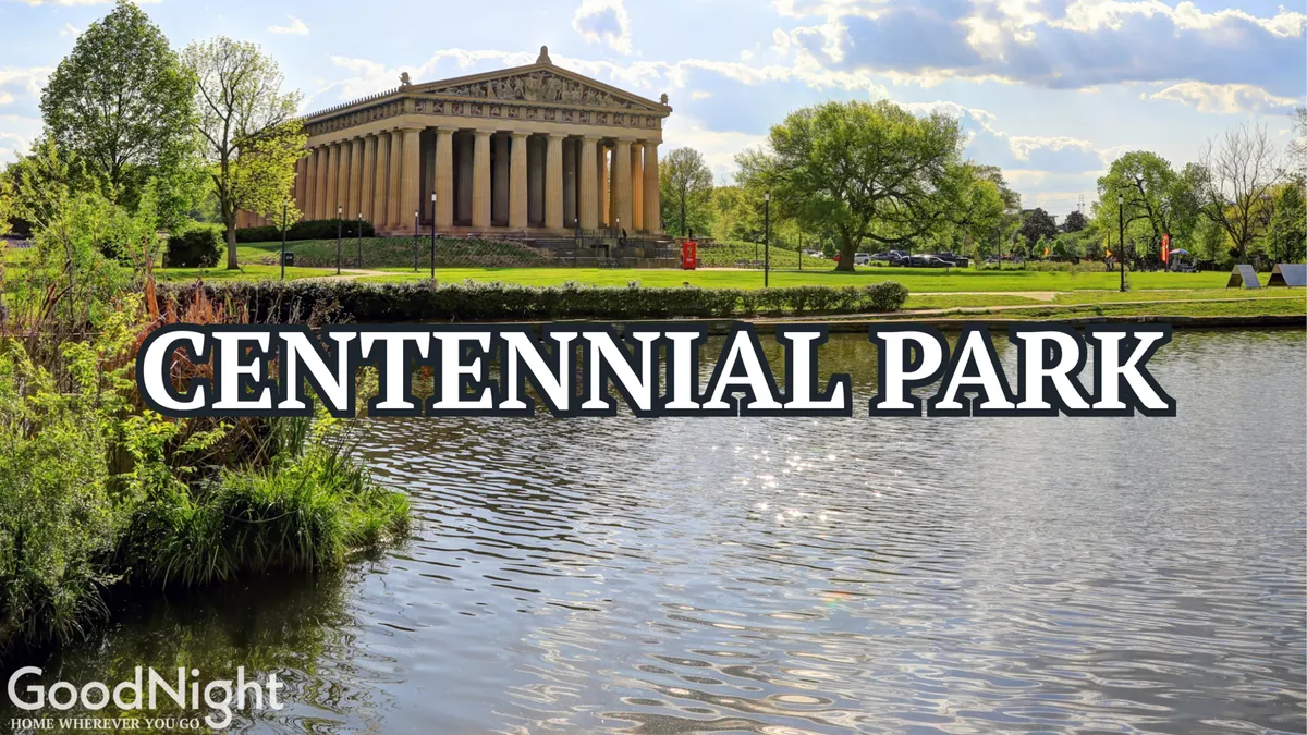 A wide view of Centennial Park featuring the full-scale Parthenon replica set against lush lawns and a tranquil lake, with leafy trees framing the scene. The image captures people strolling, picnicking, and enjoying the open, expansive green space that is central to Midtown's community life.